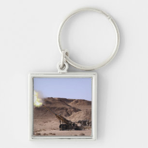 Flame and smoke emerge from the muzzle keychain