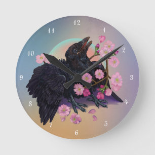 Fledgling Crow with apple blossoms Round Clock