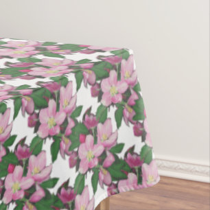 Fleurs de pommier pastel sur nappe blanche