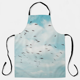 Flock of grey dove fly on vintage blue sky. above, apron