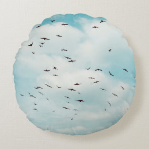 Flock of grey dove fly on vintage blue sky. above, round pillow