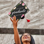 Floral Border | Custom School and Class Year Graduation Cap Topper<br><div class="desc">Cute personalized grad cap topper features your school and class year with "graduate" in the centre,  in white brush script lettering on a black background adorned with pink watercolor flowers and green foliage.</div>