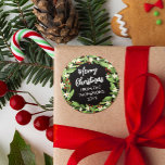 Floral Red Berry Greenery Wreath Merry Christmas Classic Round Sticker<br><div class="desc">Beautiful floral Christmas sticker with a wreath of sage green greenery,  white flowers,  and red berries,  Merry Christmas in a white script and your name and the year.</div>