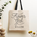 Flower Girl Modern Script Gold Wedding Name Tote Bag<br><div class="desc">This modern tote bag with a minimalist casual chic script calligraphy design reading FLOWER GIRL as well as your custom name features clean lines to create a sleek and sophisticated appearance. The understated style with the little printed gold heart detail adds a touch of sophistication to her wedding day look....</div>