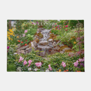Flowing Waterfall with spring flowers Doormat