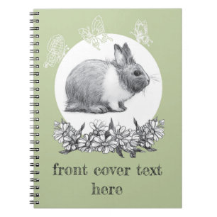 Fluffy hare with butterflies on green background notebook