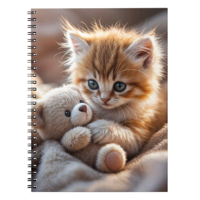 Fluffy red kitten playing with a tiny teddy bear,  notebook (Front)