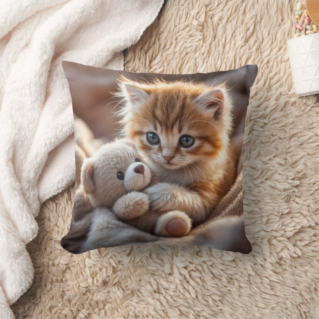 Fluffy red kitten playing with a tiny teddy bear,  throw pillow (Blanket)