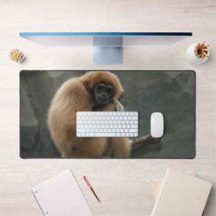 Fluffy white-handed lar gibbon desk mat