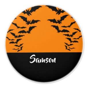 Flying bats on orange ceramic knob