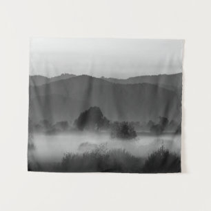 Fog rolling through valley in black and white tapestry