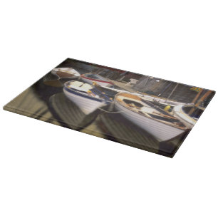 Fog surrounds four boats docked. cutting board