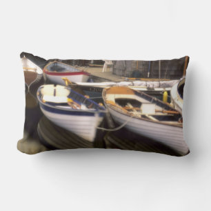 Fog surrounds four boats docked. lumbar pillow