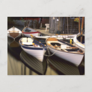 Fog surrounds four boats docked. postcard