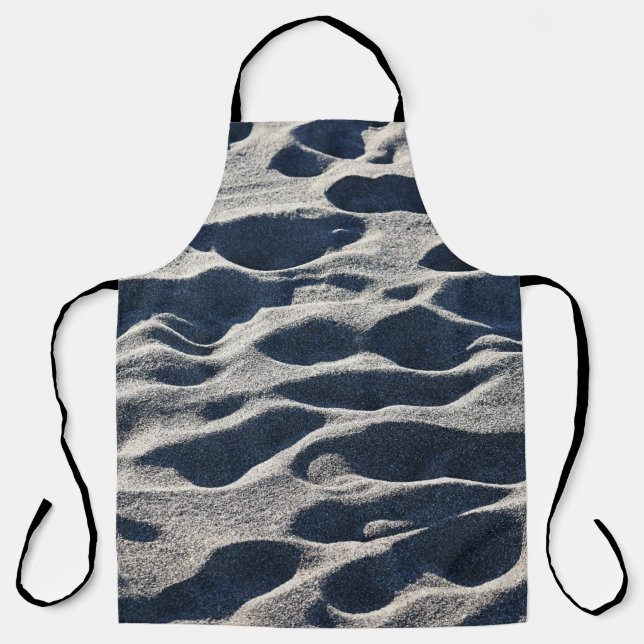 Foot prints on sand during daytime apron (Front)
