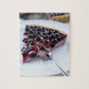 Fork slicing blueberry pie on plate jigsaw puzzle