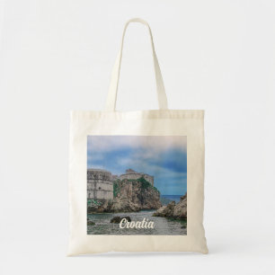 Fortress walls, rocky coast and sea in Croatia Tote Bag