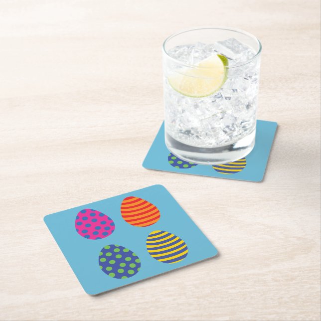 Four coloured easter eggs square paper coaster (Insitu)