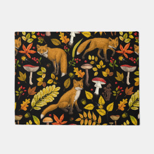 Foxes and buttercups on black doormat