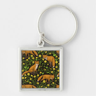 Foxes and buttercups on black keychain