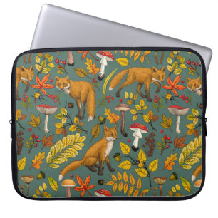 Foxes and buttercups on black laptop sleeve