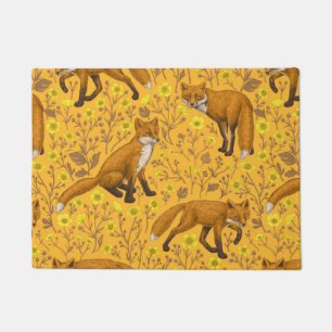 Foxes and buttercups on orange doormat