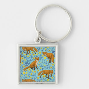 Foxes and buttercups on pool blue keychain
