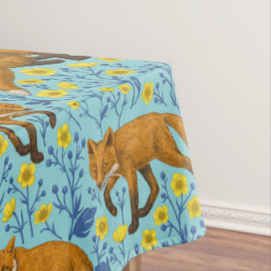 Foxes and buttercups on pool blue tablecloth