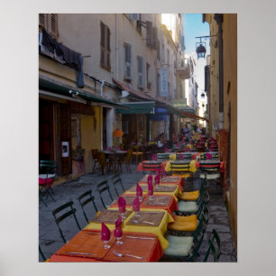France, Corsica. Tables of cafe set up in narrow Poster