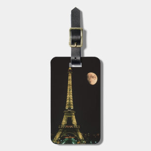 France, Paris. Eiffel Tower at night with Luggage Tag