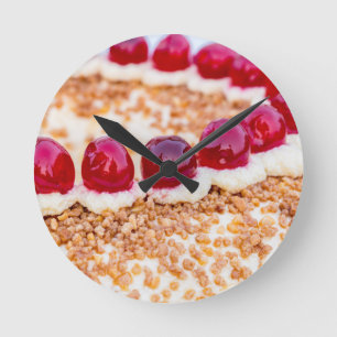 Frankfurt crown cake with cherries on rustic wood round clock