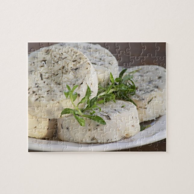 French goat cheese - chevre - with herbs on a jigsaw puzzle (Horizontal)