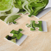Fresh iceberg lettuce cut in half, on white jigsaw puzzle (Side)