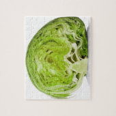 Fresh iceberg lettuce cut in half, on white jigsaw puzzle (Vertical)