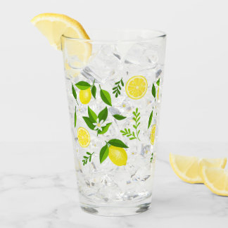 Fresh lemons with flowers and leaves glass