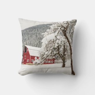 Fresh snow on red barn throw pillow