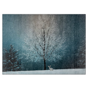 Frosty tree in the evening cutting board