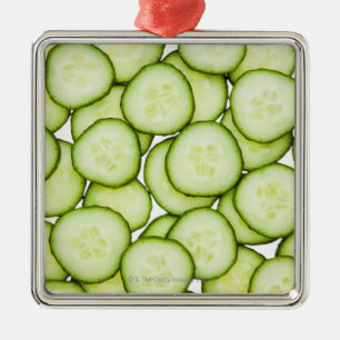 Full frame of sliced cucumber, on white metal ornament