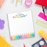 Fun Coloured Pencils Note From School Teacher<br><div class="desc">A note from School Teacher notepad personalized with the teacher's name above colourful bunting banners and a row of coloured pencils, some with patterns, in soft rainbow colours. Kindergarten teacher notepad with colourful pencils and a bunting flag banner in soft shades of the rainbow, with some patterns like stripes, dots,...</div>