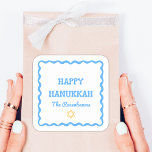 Fun Modern Wavy Border Blue Hanukkah Present Square Sticker<br><div class="desc">Celebrate the holiday season with these Happy Hanukkah stickers, perfect for adding a refined and personalized touch to your festivities. Featuring a festive blue wavy border and customizable family name text, these stickers bring a blend of classic charm and modern style to gift wrapping, party favours, or holiday decor. Ideal...</div>