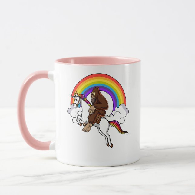 Funny Bigfoot Riding Magical Unicorn Rainbow Mug (Left)