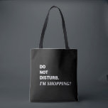 Funny Black and White Saying Tote Bag<br><div class="desc">Funny saying,  Do Not Disturb,  I'm Shopping tote bag. Featuring white lettering on a black background. Open top and black double shoulder straps for easy carrying. A carryall that's perfect for birthday,  Mother's Day or holiday gift giving. Kimberly Brett.</div>