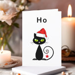 Funny Black Sitting Santa Claus Christmas Cat Holiday Card<br><div class="desc">Shows a black cat with green eyes and curly tail. The cat wears a red Santa Claus hat and has a Christmas star ornament hanging from its tail. The text above reads "Ho, " which is an unenthusiastic "ho ho ho." Customize and personalize the inside text, which reads "Man, it's...</div>