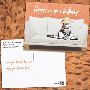 Funny Cat Wearing a Sun Hat on a Couch Postcard