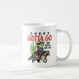 Funny Cowboy Frog Riding Raccoon "Vibes Are Off" Coffee Mug