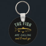 Funny Fishing Quote The Fish Are Calling I Must Go Keychain<br><div class="desc">Funny and humourous design for fisherman, angler, those who love river and lake fishing. This vintage, retro and distressed merchandise is great to wear on your fishing trip to the cabin by the wood. Bring your gears, fishing rod, fishing reel and let's catch some fish. Great Christmas gift and birthday...</div>