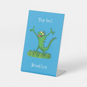 Funny green smiling animated iguana lizard pedestal sign