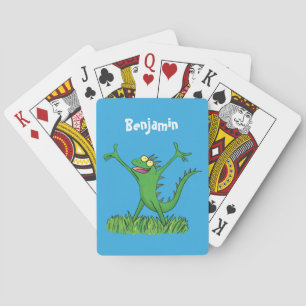 Funny green smiling animated iguana lizard playing cards