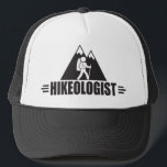 Funny Hiking Trucker Hat<br><div class="desc">HIKEOLOGIST. Humourous title for someone who loves hiking - and, who has a sense of humour. Makes a unique and funny gift for a hiker, trekker, mountain climber. A black and white design that features tall, snow-capped mountains in the background and a hiker with backpack in the foreground. Find more...</div>