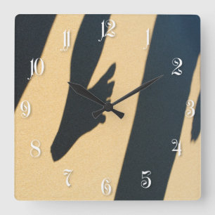 Funny human shadows on the beach sand square wall clock